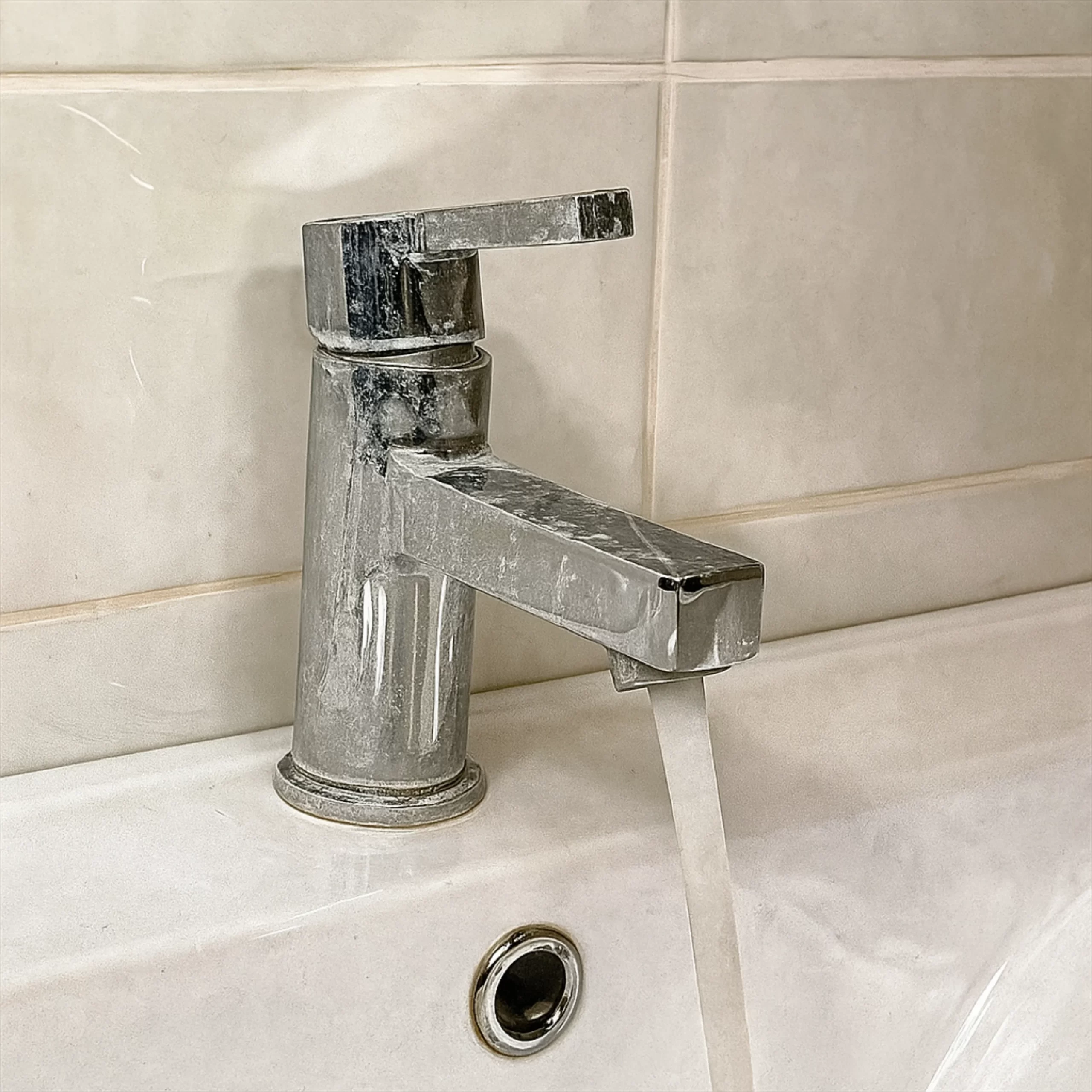 white scaling formation on tap